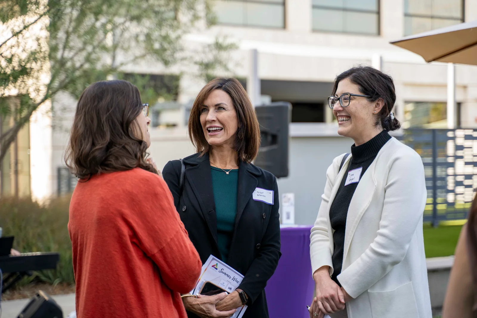 Three women in conversation on the lawn at the 2025 Summer Wine Social